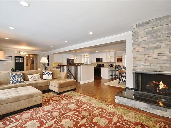 The corner raised hearth fireplace in the living room features new gas logs with beautiful stacked stone. Notice all the recesse