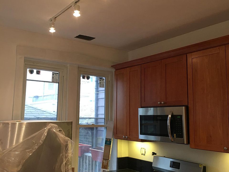new kitchen with track lighting throughout the unit