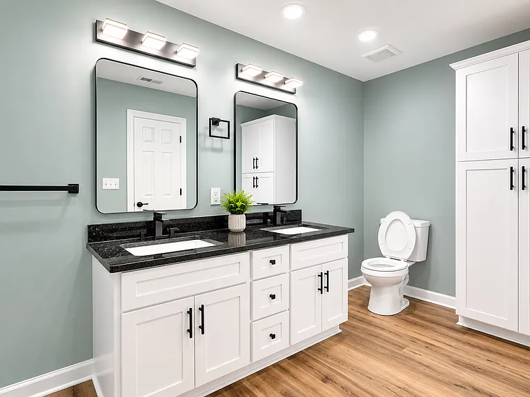 Master bathroom with double vanity & linen closet.