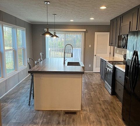 Spacious kitchen that opens onto back deck with double sliding doors.