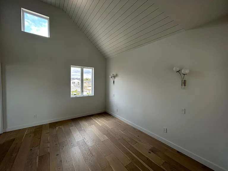Bedroom with oversized windows high ceilings and walk-in closet private bathroom