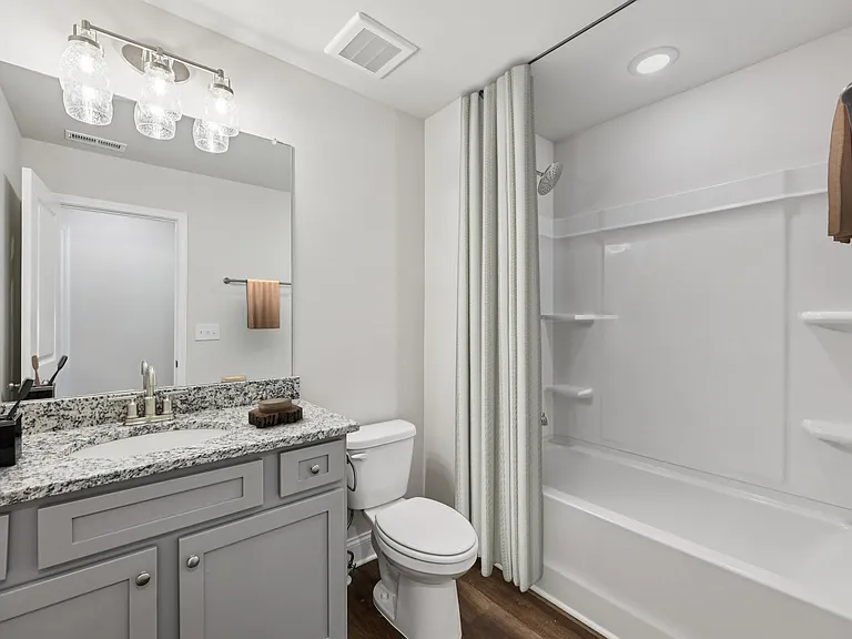 Secondary suite bathroom with a tub and shower combination