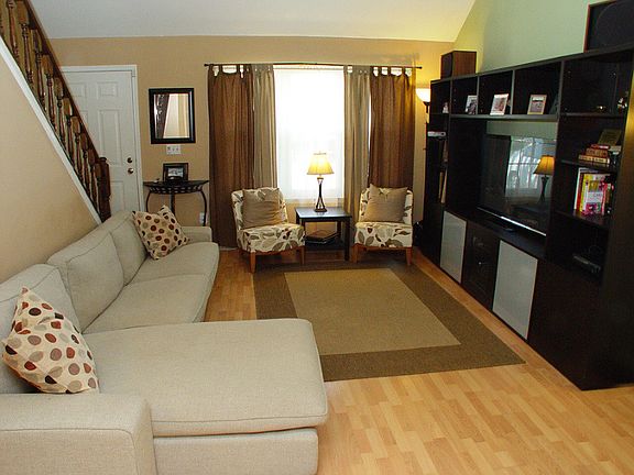 Living room with Pergo floors, vaulted ceiling and triple windows for plenty of natural light.