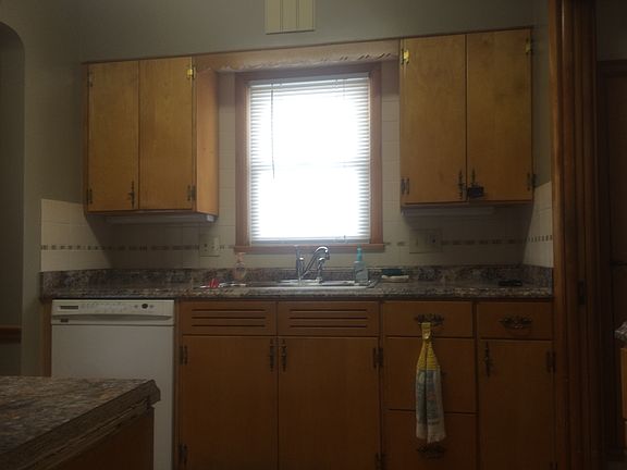 Kitchen has dishwasher and new countertops & backsplash
