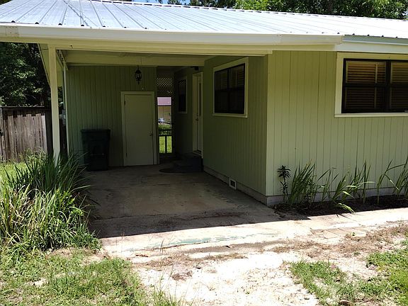 carport showing laundry room, kitchen entrance & screened access door to rear yard