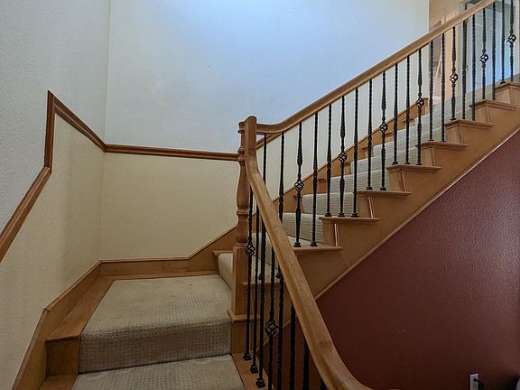 Stairs located on the left side of the entrance door