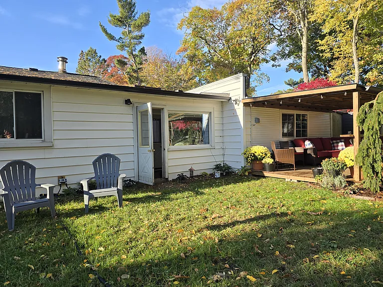 back of house with outdoor seating area and deck.
