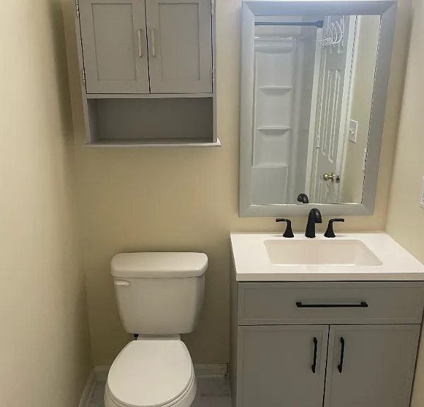 Back bedroom with mirror, shelf and vanity