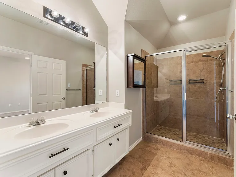 Master bathroom with walk-in shower and two sinks