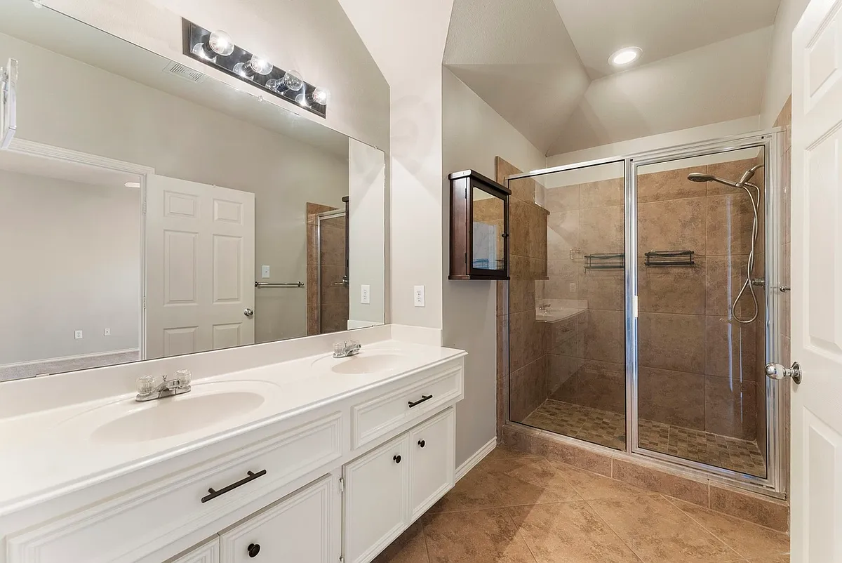 Master bathroom with walk-in shower and two sinks - 922 E Heights Hollow Ln