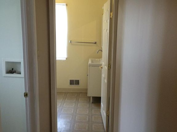 hallway looking into bath/laundry room on right