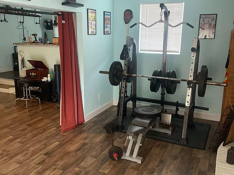 Multipurpose bonus room with durable flooring, a window for natural light, and open space for a home gym or lounge setup.