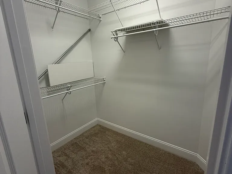 secondary closet, those are white shelves to place on the wire closet shelving