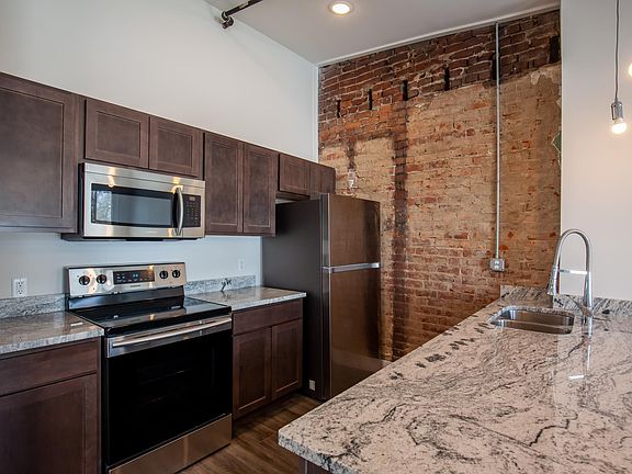 Granite kitchen countertops with full size refrigerator and electric range, microwave, dishwasher and garbage disposal. Quality finishes with a 4-5 person counter-bar.