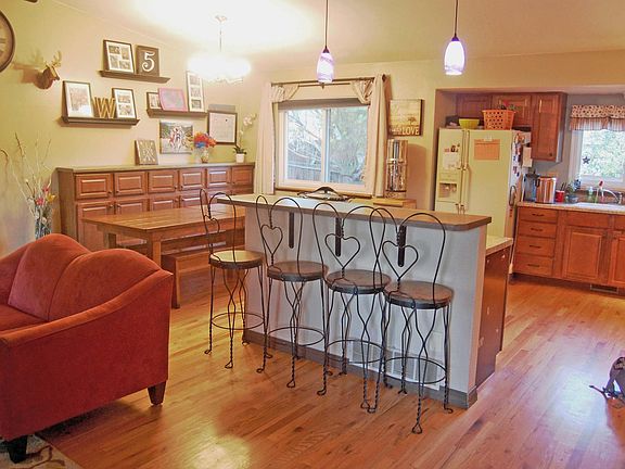 Open concept kitchen and dining. Newer fridge (black) in pla