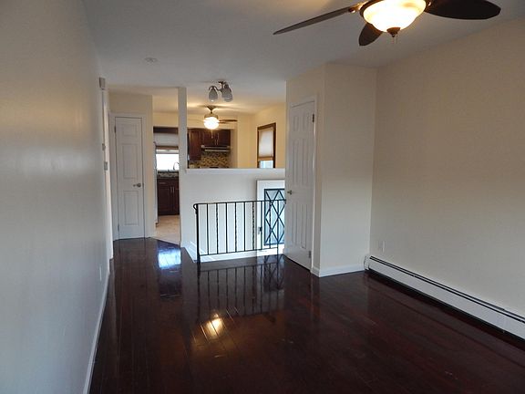Center hall entrance, with coat closet at top of stairs Wrought iron railing