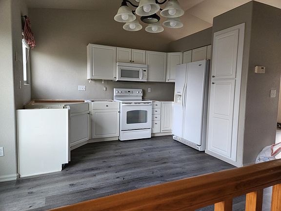 Kitchen featuring new floors and a soon to be installed granite countertop