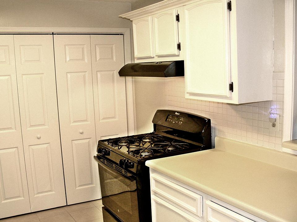galley kitchen with laundry closet and storage.