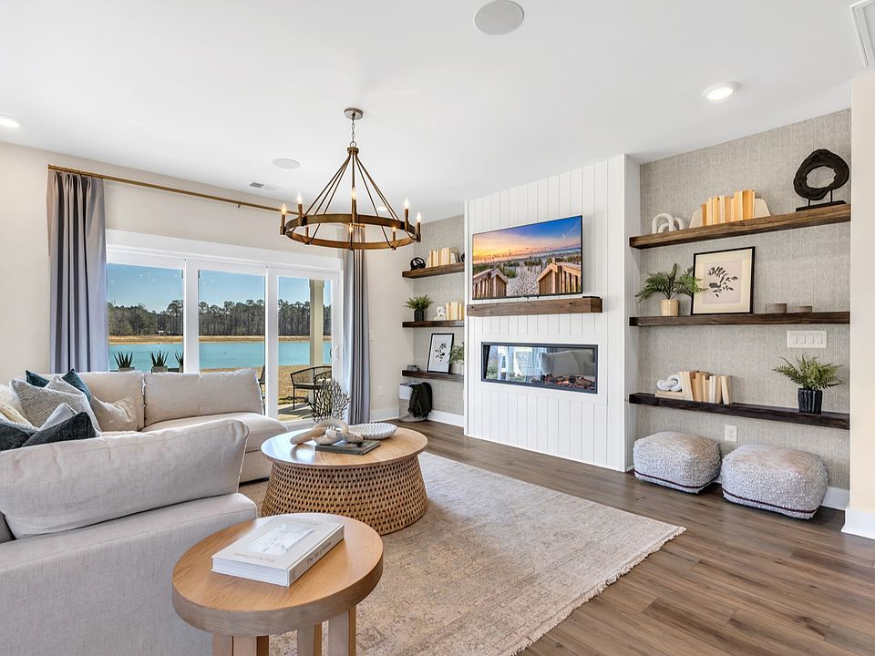 Open concept living room in Chestnut Farms in by DRB homes offering lots of seating and a cozy envir