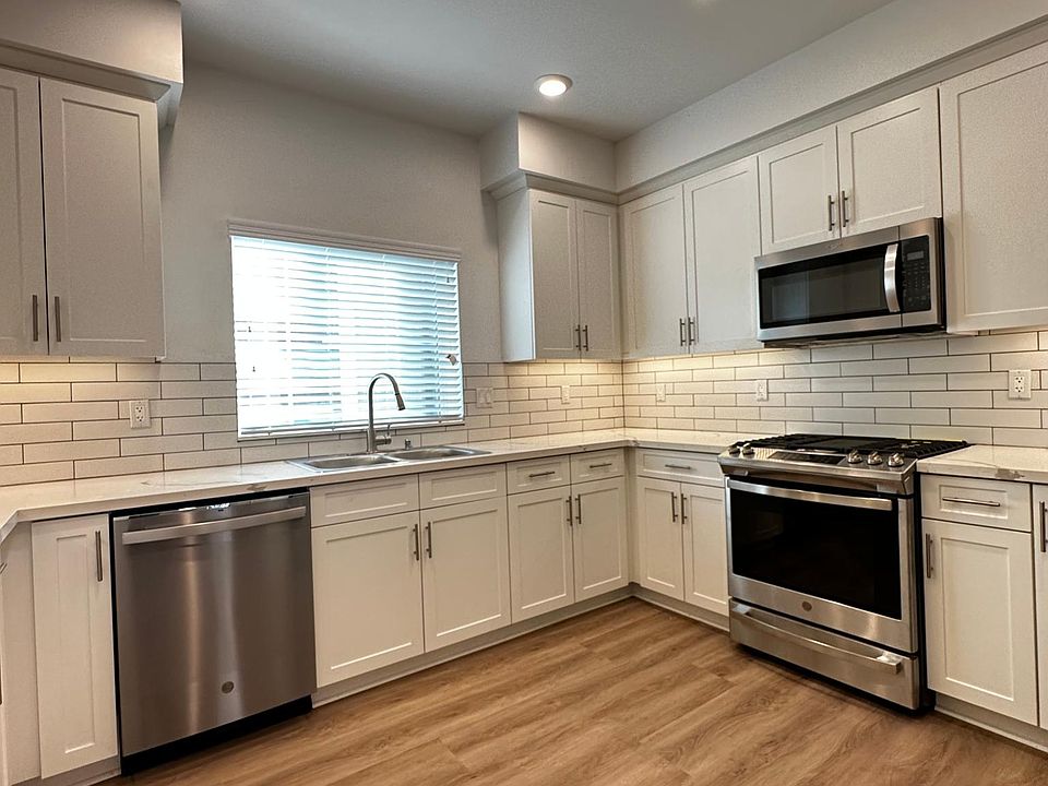 kitchen with under cabinet lighting and brand new appliances