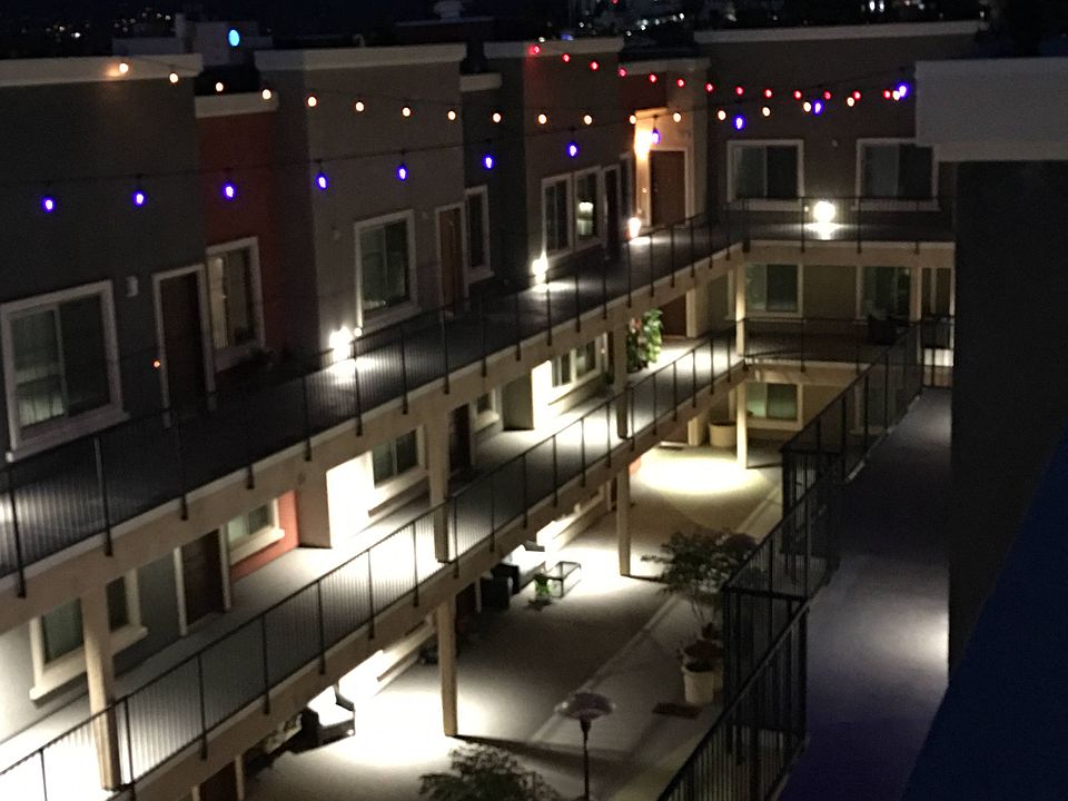 Night time view of inner courtyard at City Plaza Apartments in Escondido, California.