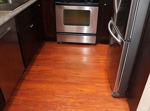 Kitchen with stainless steel appliances, granite countertops and hardwood floors