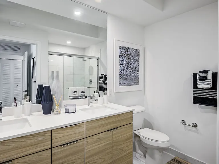 West Phase Bath with oak cabinetry, white countertop, and hard surface flooring