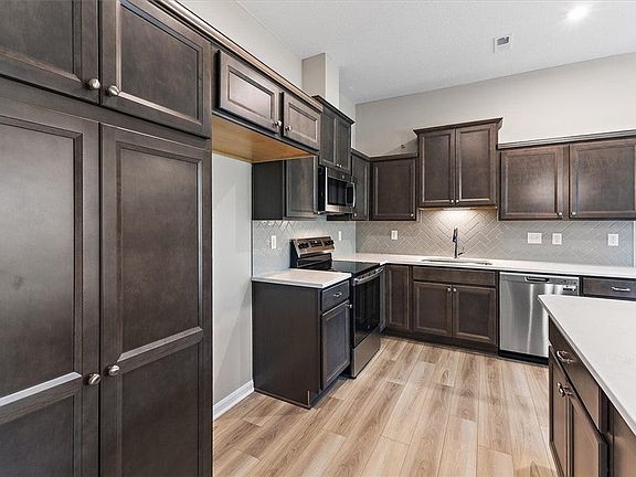 Rich dark cabinetry pairs beautifully with light c