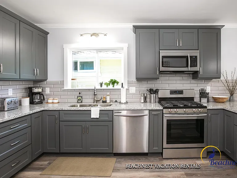 Open and inviting chef's kitchen with stainless appliance and thoughtful design.