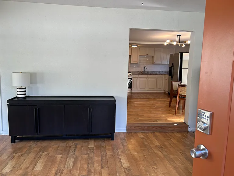 Full view from front door through living room to kitchen area