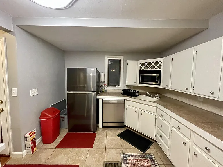 Kitchen - fridge, dishwasher, sink, build in cabinets, cleaning supplies