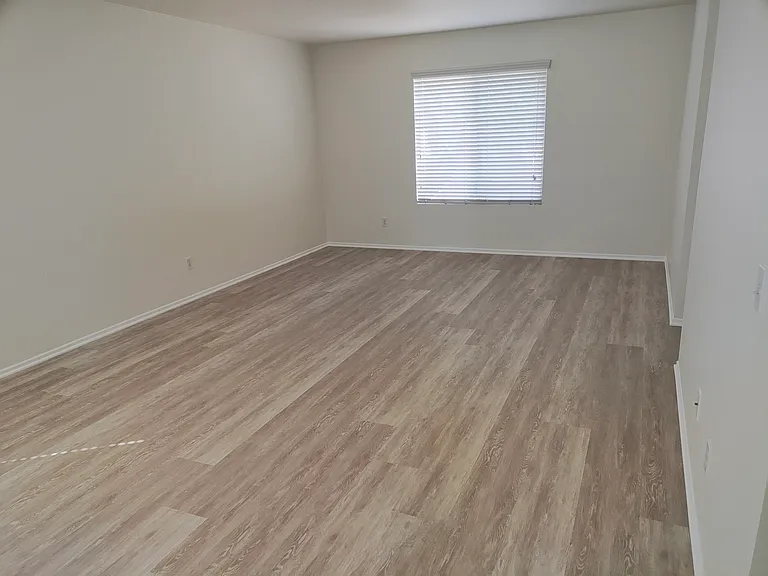Primary bedroom, with entrance to en-suite bathroom on the right