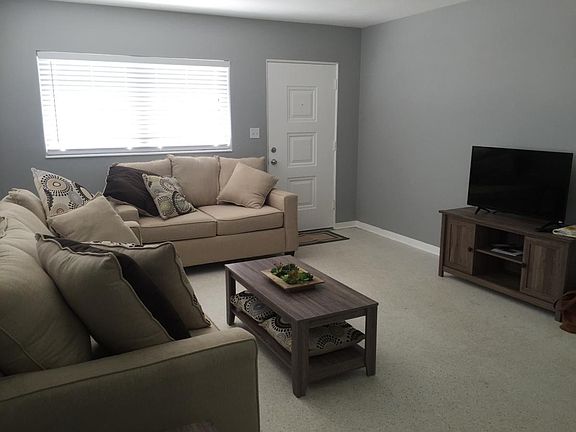 Open and bright living room with large windows and new, mode