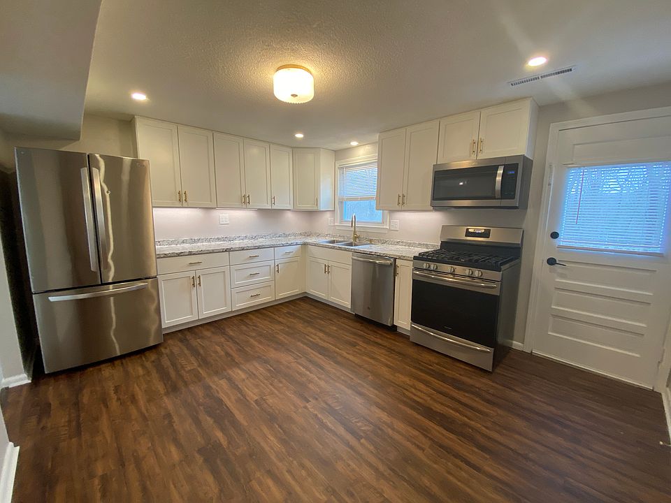 Modern and newly renovated white kitchen with stainless steel appliances, new countertops, cabinets, flooring and recessed lights! Gas range!