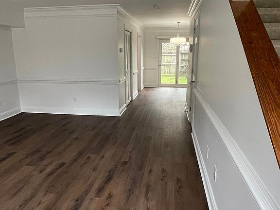 Living room and dining nook areas. Glass door out to private fenced in backyard & patio.