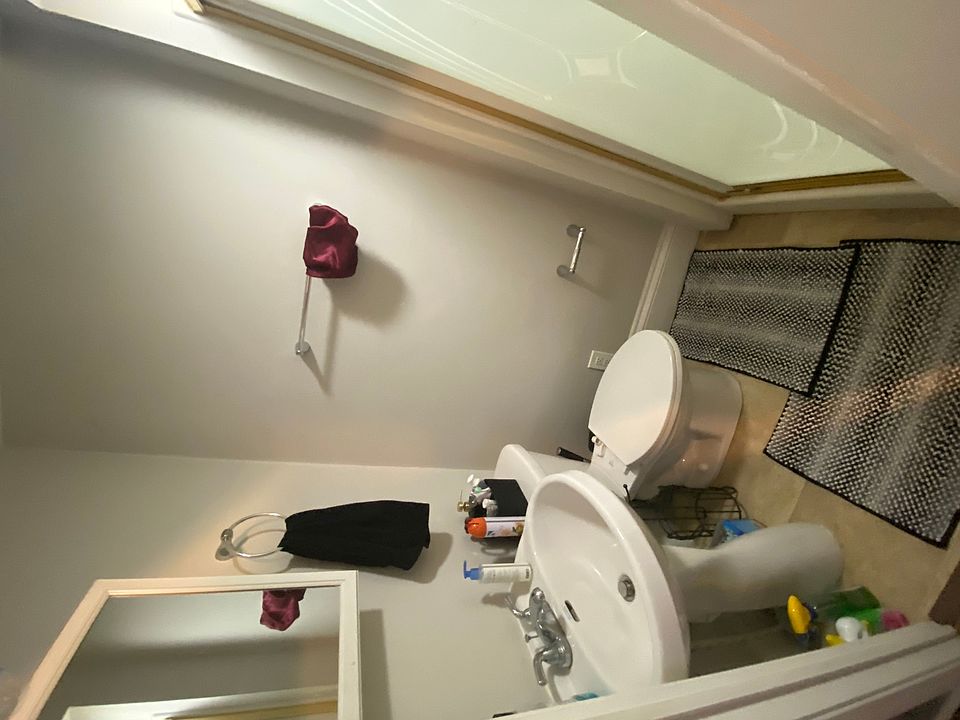 This room includes a fullsize bed, has a full bathroom to the left and another room to the right.