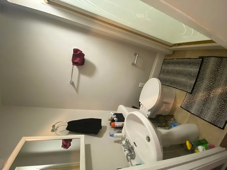 This room includes a fullsize bed, has a full bathroom to the left and another room to the right.
