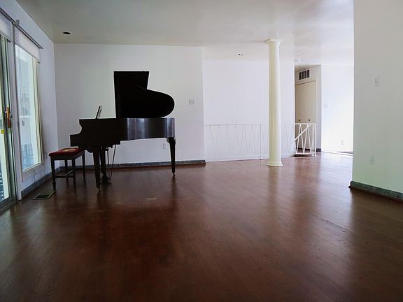 Living Room - View from Fireplace 
Patio Doors on left. Open to Dining Room on right.