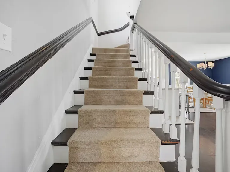 Large, beautiful stairwell leading up to the second floor.