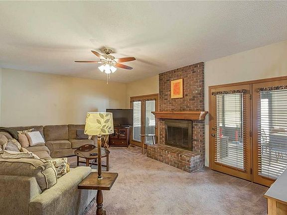 Family Room with Brick Fireplace, connects to kitchen and 3 