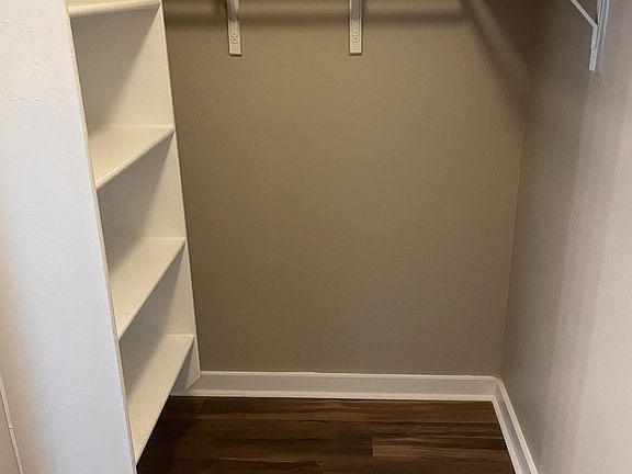 Large master closet with custom shelving makes staying organized a breeze!