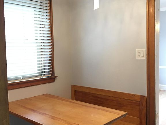 Separate breakfast nook located between dining room and kitchen, with built in table and benches.