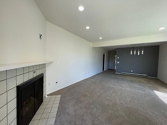 View of living room and fireplace from patio side