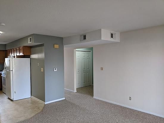 Open living room and kitchen area. Looking toward washer and dryer.