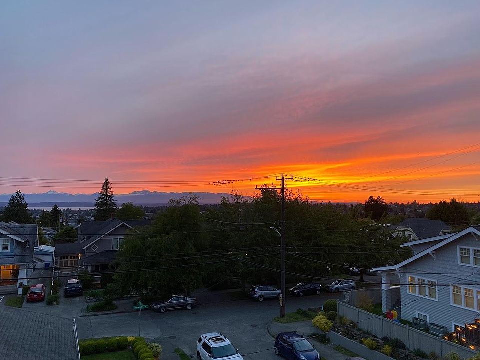 West facing sunset over Olympic mountain range from main balcony off living room