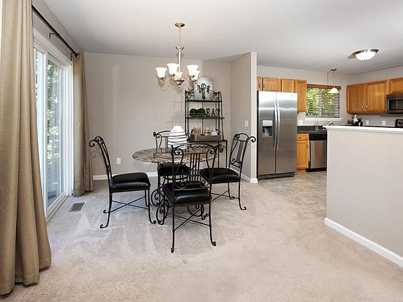 Dining area opens to kitchen and sliding doors to deck