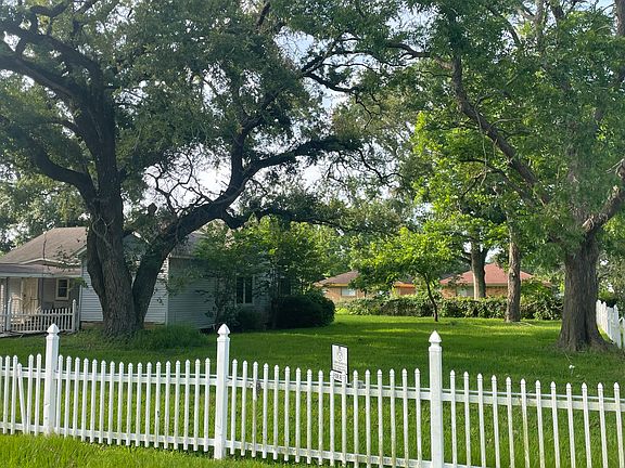 This is a view from the street down the side yard with its white picket fence.