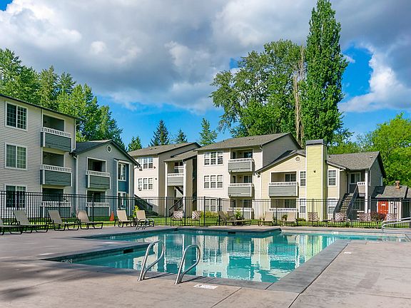 Swimming pool surrounded by lounge chairs.
