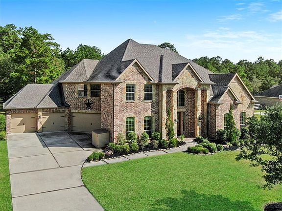 Drive up this nice, long driveway, with lots of parking area, to any one of the four garages!!