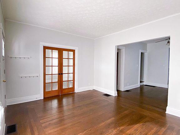 The living room connects to a study through french doors and the dining room to the right.